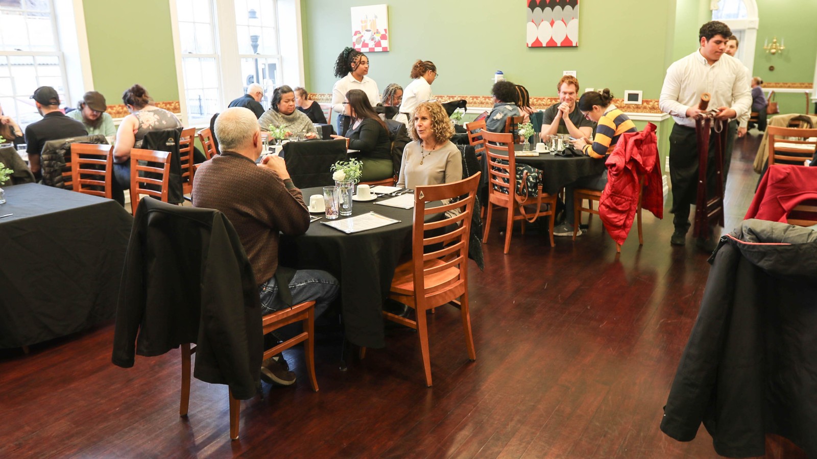 crowd sitting down at vaulted cuisine restaurant 