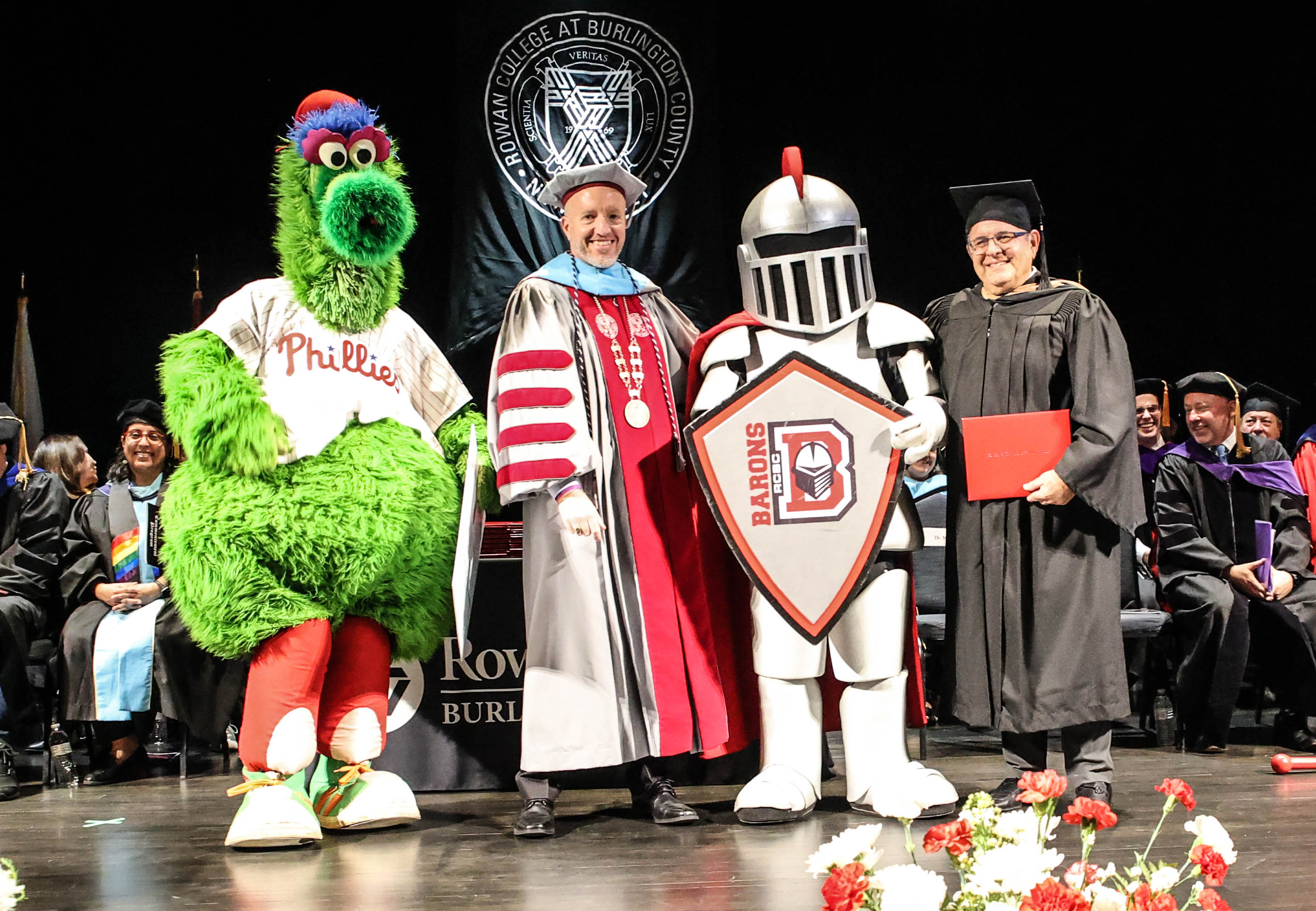 Philly Phanatic, President Cioce, Barry the Barron, Stanley Middleman on stage at commencement