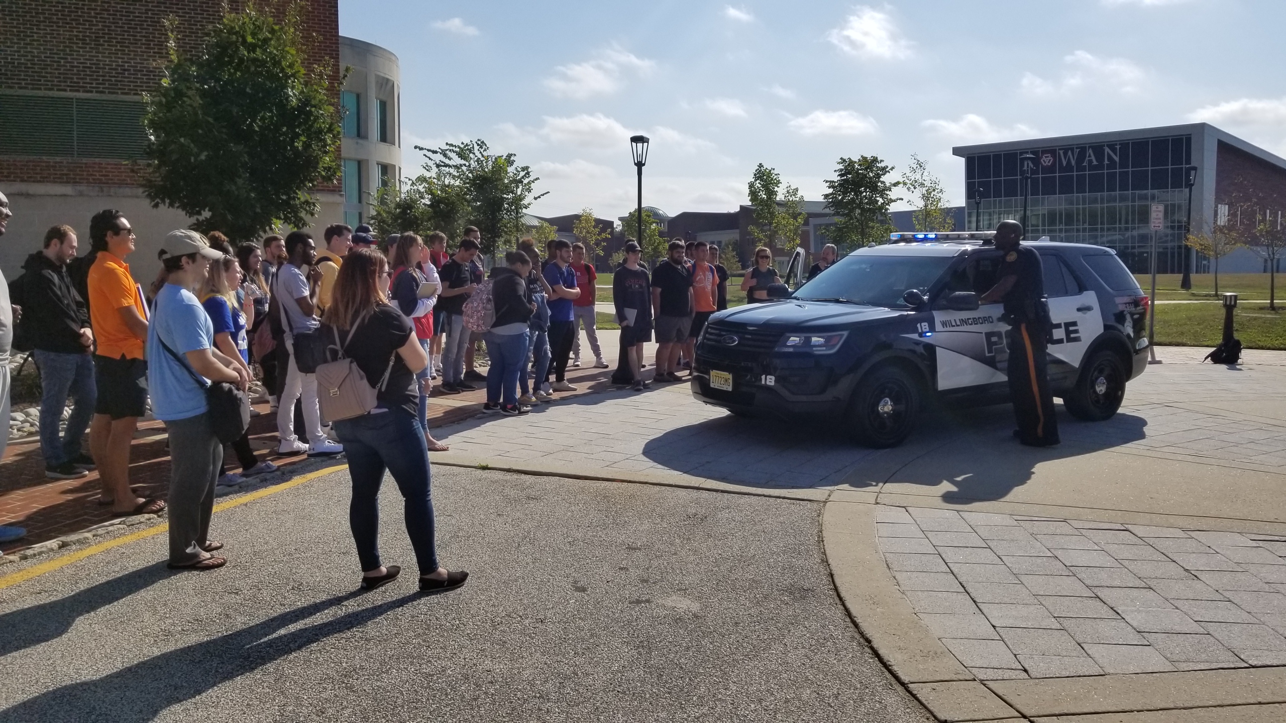 RCBC students gathered outside around Mount Laurel police officer and vehicle