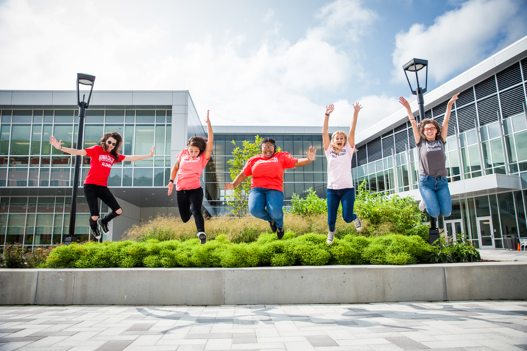 students jumping in front of Student Success Center