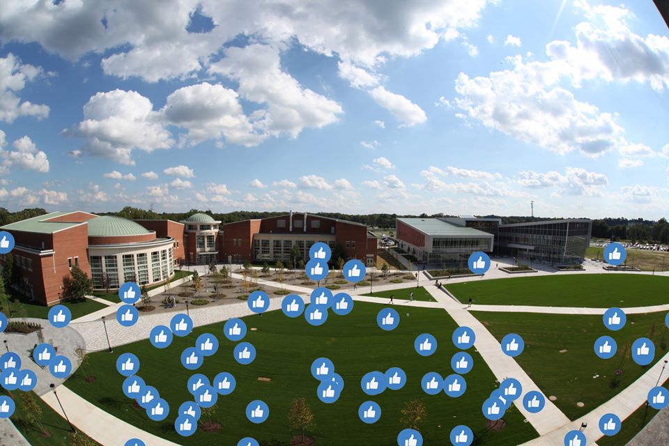 campus photo with thumbs up icons