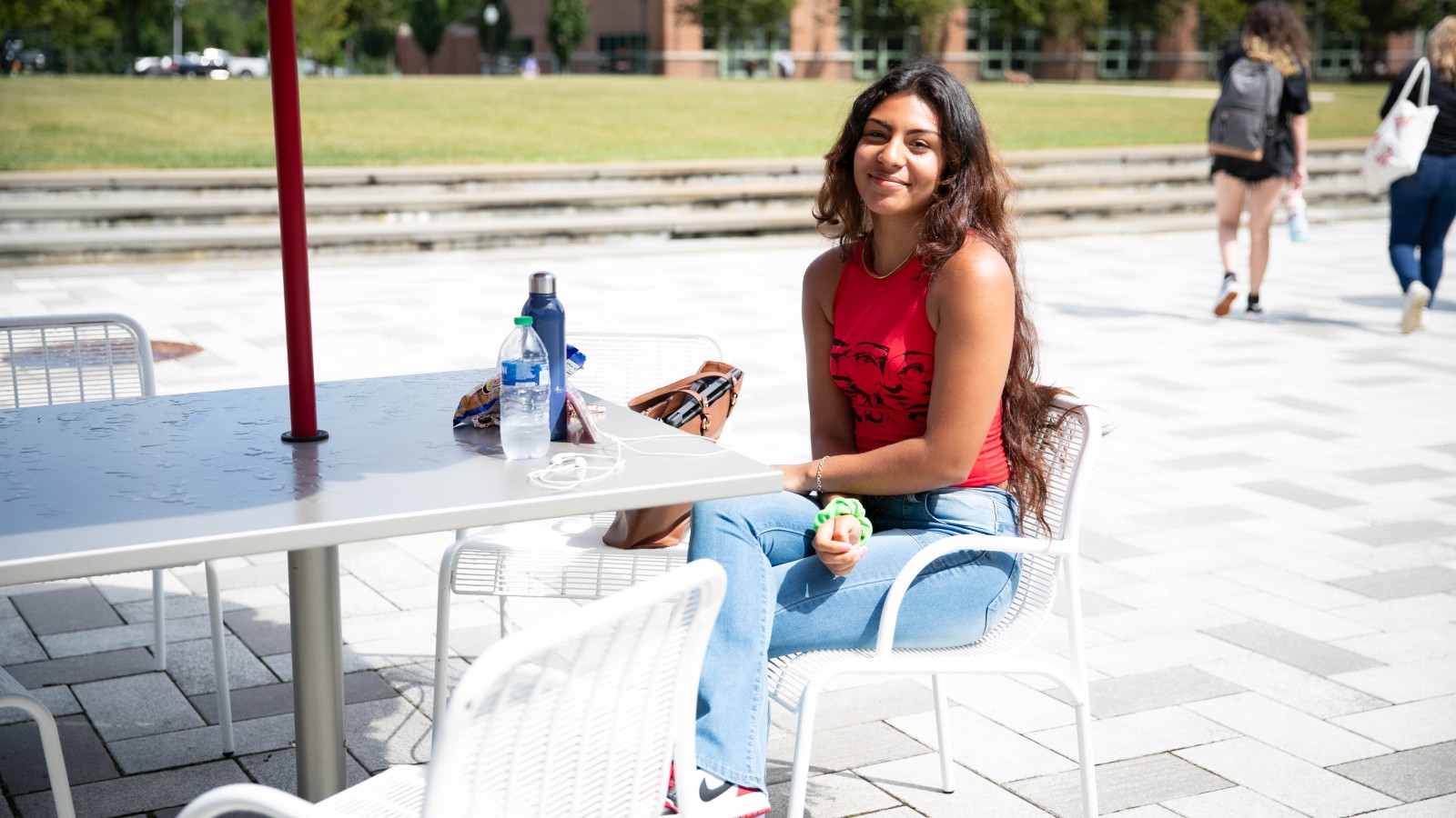 female student sitting outside at table