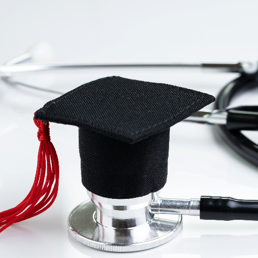 Stock photo of stethoscope with graduation cap