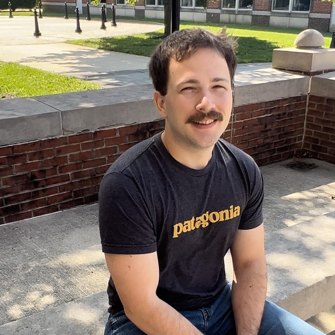 RCBC student, Jonathan D’Arpino, sitting on concrete bench