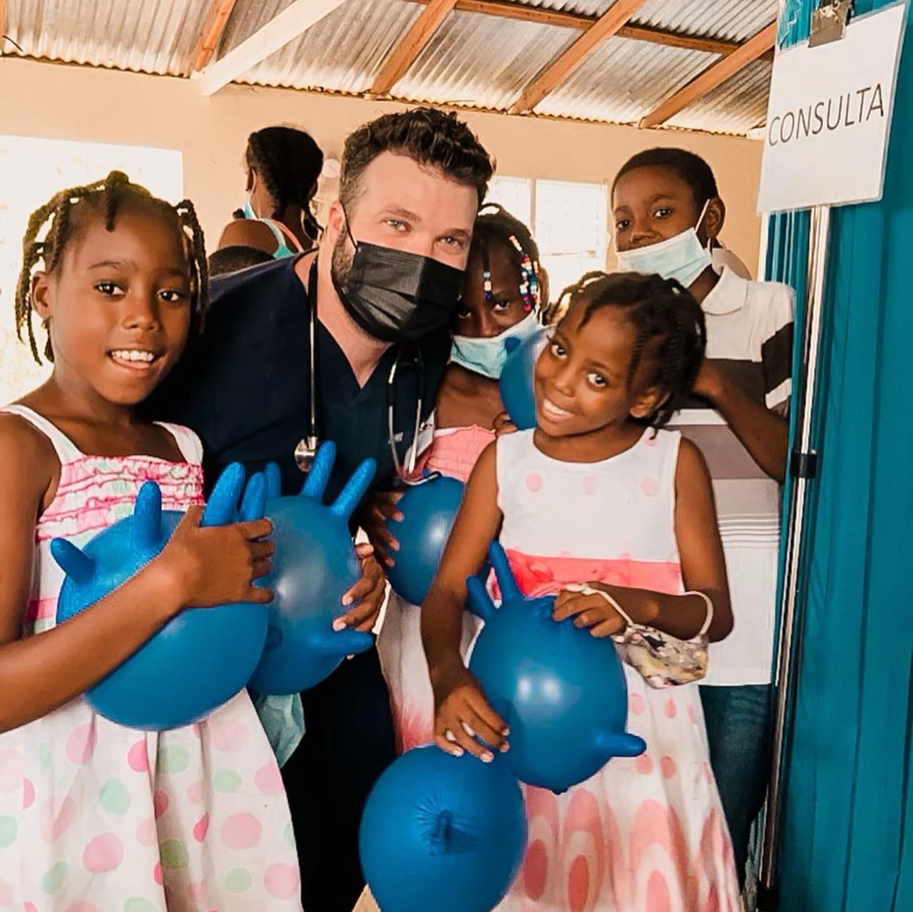 Joseph Randazzo with children at a medical clinic