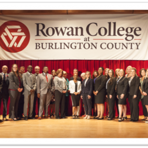 Dress for Success students in front of RCBC logo 