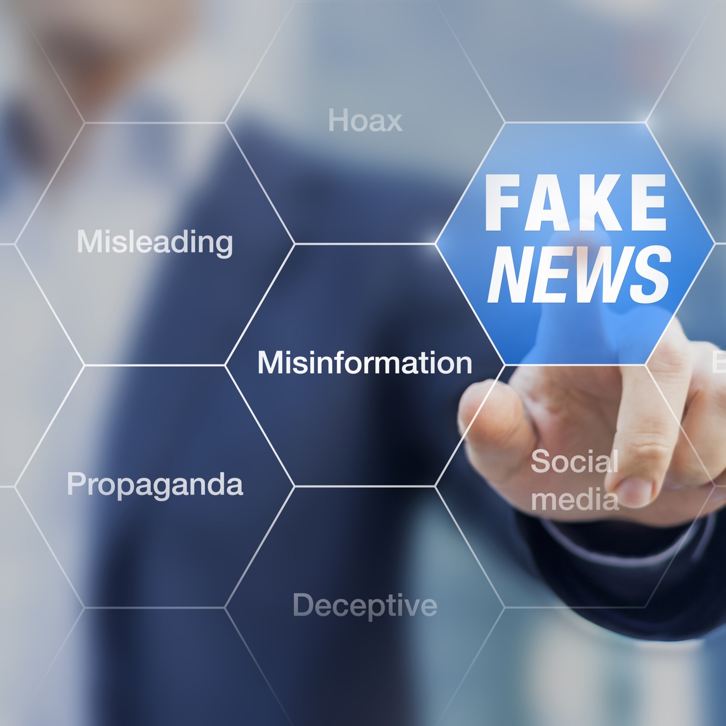 man pointing to various words including "fake news, misinformation, misleading"