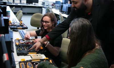 Cybersecurity team members Molly Connolly, Faiz Ibrahim, and Allison Warren work together