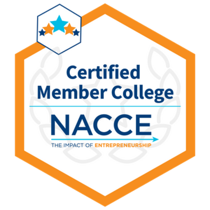 Certified Member College NACCE logo. A yellow-orange hexagon with its vertices pointing vertically encapsules navy blue text that reads "Certified Member College" separated by a thin sky blue line. Written below is "NACCE" underlined by a sky blue arrow pointing right with a text in all caps underneath that reads "The Impact of Entrepreneurship". A smaller hexagon outlined in thin navy blue line lies on the top left of the design, and holds five stars aligned to shape an upward arrow.