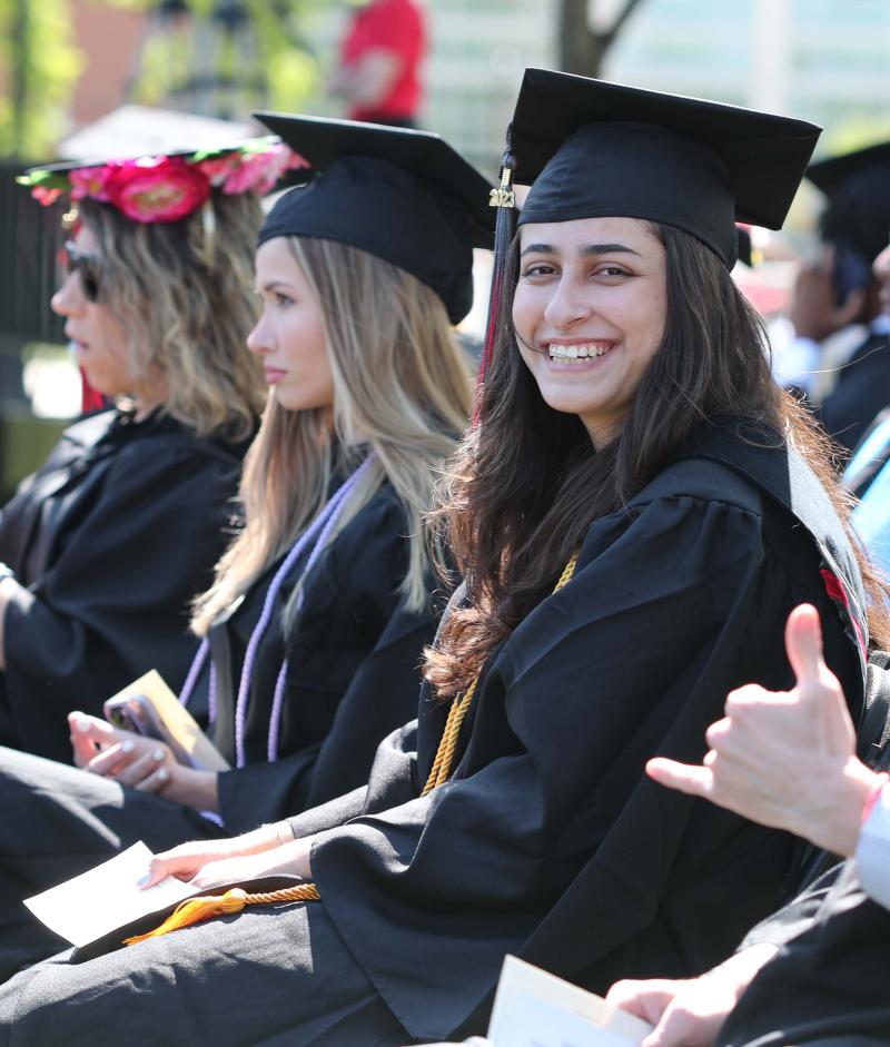 RCBC student in cap and gown smiling at graduation 