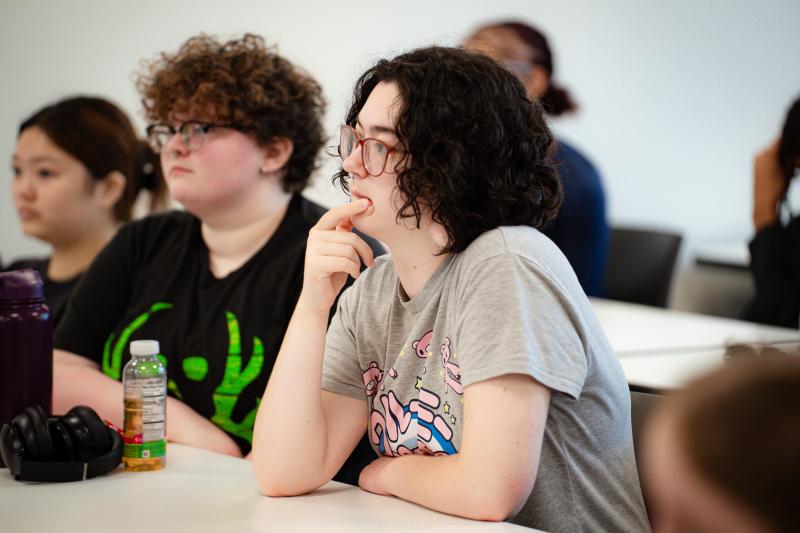 EOF student holding there hand over their chin during classroom discussion