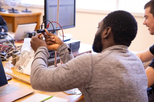 Physics students working on a project at their desk