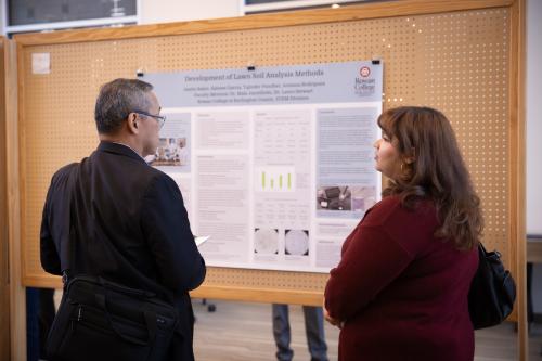 Campus visitors looking at the Student Research Poster Symposium displays