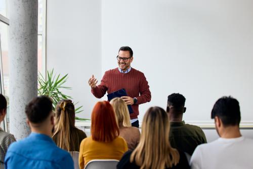 Instructor Leading Engaging Workshop Session With Participants in Modern Bright Room