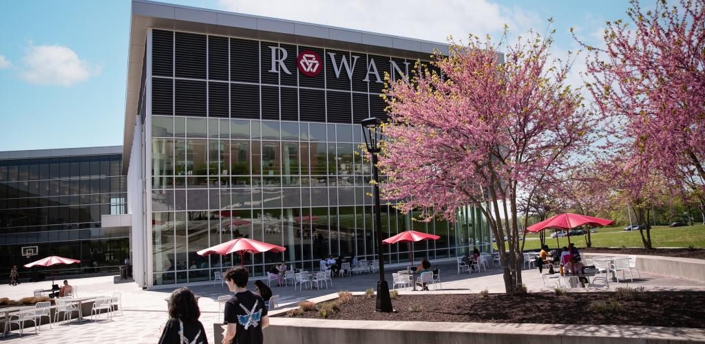 RCBC Campus in spring time with two students walking on the quad path