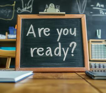 Mini chalk board on desk with the words are you ready