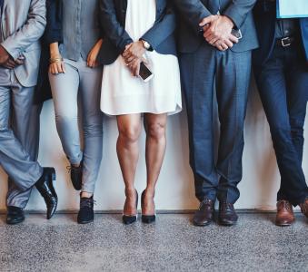 Group of business people standing against the wall 