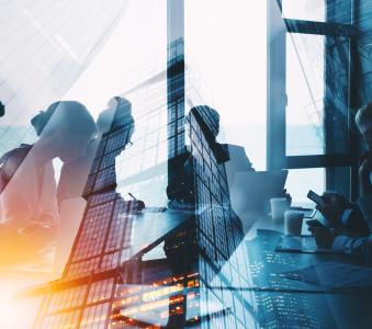 Generic business meeting at a table over layered with skyscrapers image 
