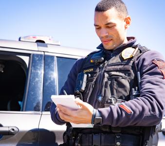 Local police officer writing down on a notepad