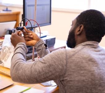 Physics students working on a project at their desk
