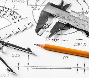 Mechanical engineering decorative image using pencil, protractor, and metal caliper 