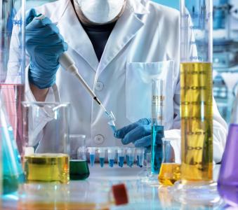 Researcher holding test tube with chemist material in the investigation lab