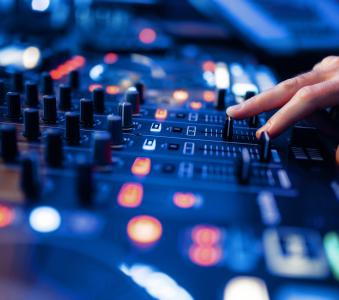 Sound operator hands at the volume control panel