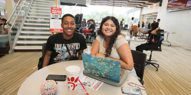 Two RCBC students sitting at table in SSC lounge