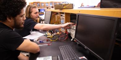 Two students working on electric engineering project