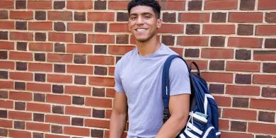 Eli Booth leans against a wall.