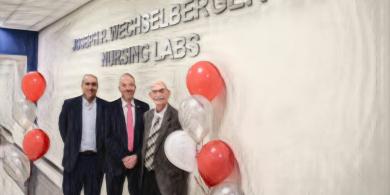 President Cioce with Joseph Wechselberger and a board of trustee member inside Health Sciences building (photo has crayon filter applied)