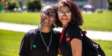 Two RCBC students holding each other and smiling