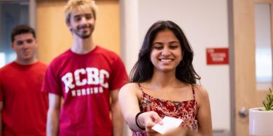 Students line up at the welcome desk of the test center.