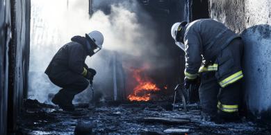 Firefighters investigating a fire scene