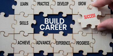 Build Career text on wooden puzzle pieces with success puzzle piece over deep blue background. Businessman hand. Career development and professional growth concept with copy space