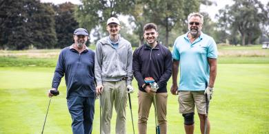 Foursome group of golfers smiling for camera at RCBC's Foundation Golf Tournament