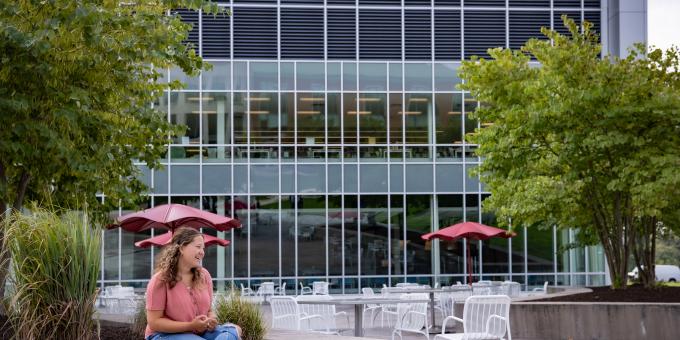 A student poses outside of the Student Success Center