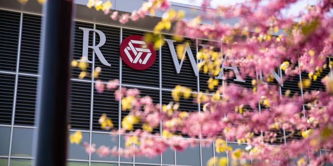 Student Success Center building sign in background with pink tree in foreground