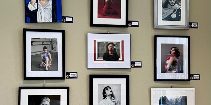 Group of student art work pieces hanging on the Arts Campus wall