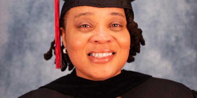 Sherria Hunter headshot wearing graduation regalia.