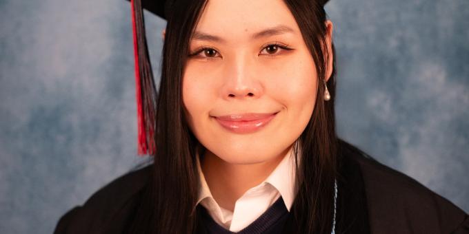 Headshot of Yvonne Tai in graduation regalia.
