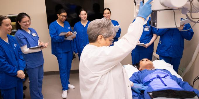 RCBC Radiography students watch a demonstration from a professor.