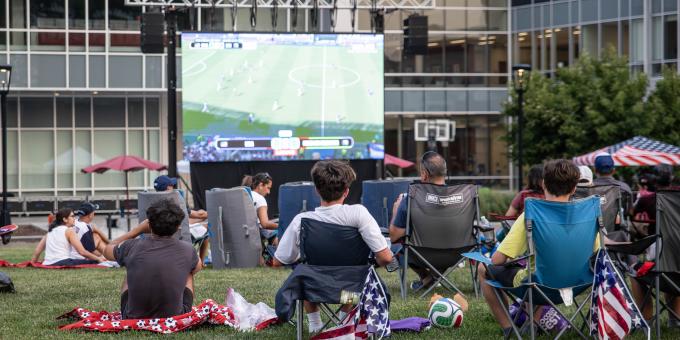 People gather on the SSC quad to watch a FIFA world cup game.