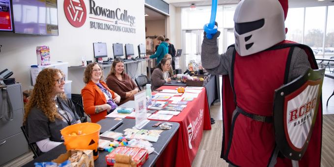 Barry holding a balloon sword while attending Fall into Good Health Fair