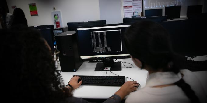 Cybersecurity students work on a computer in the RCBC computer labs.