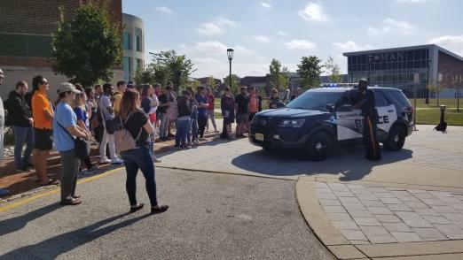 Police officer speaks to students on campus