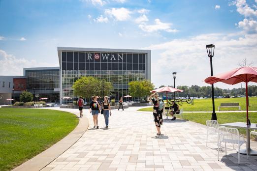 Students walking the path of the quad by Student Success Center