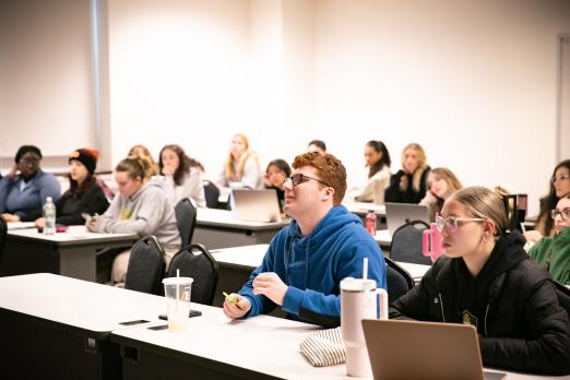Psychology students in class paying attention to the lecture.