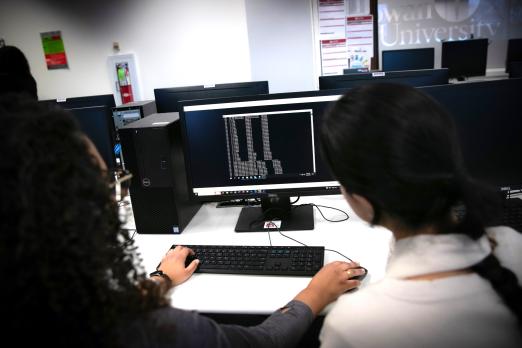 cybersecurity students working on coding skills