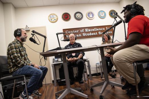 From left to right: Jay Varga, Stephen Hodsdon, Jennifer George, Reginald Taylor chat at microphones.